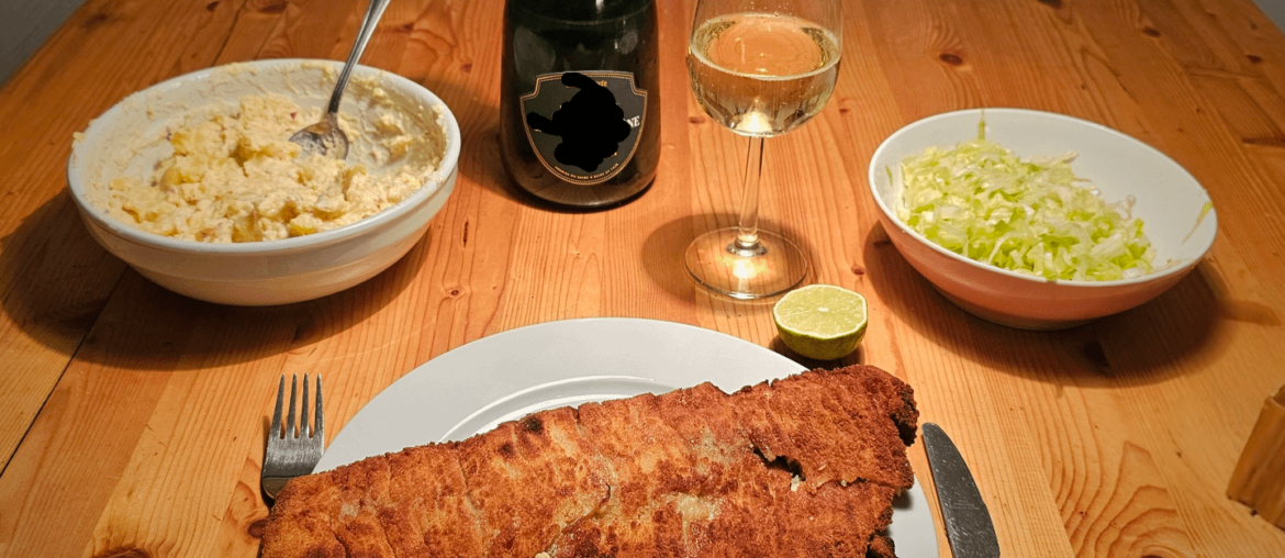 Baked Waldviertel organic carp fillet with homemade potato-mayonnaise salad and champagne.