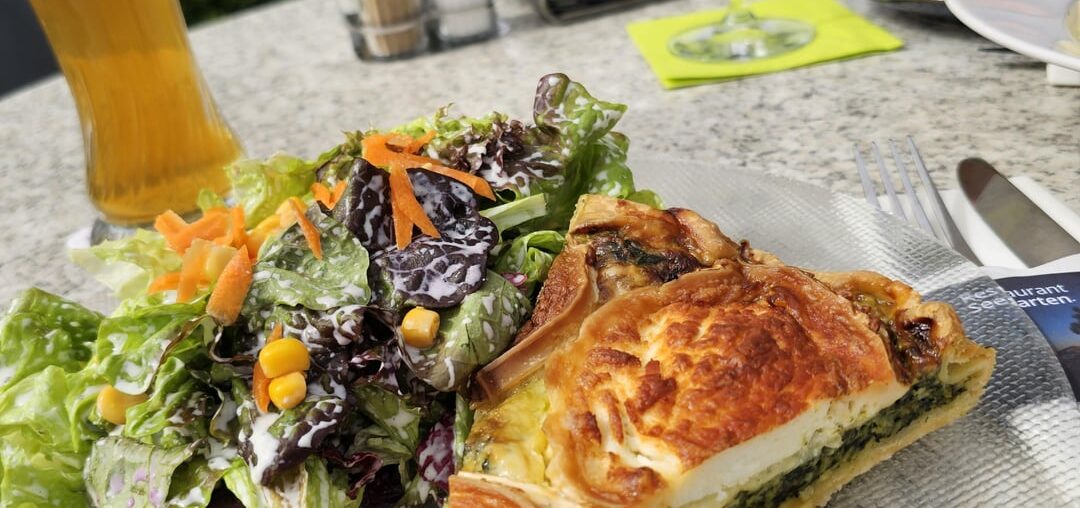 Homemade spinach quiche with goat's cheese and mixed salad, served in Allensbach (Germany)