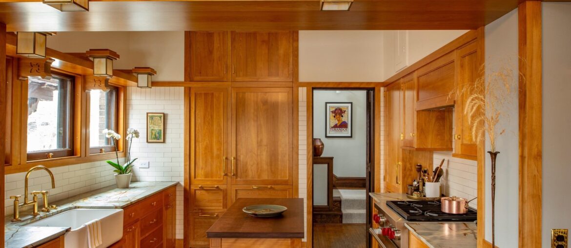 Restored kitchen with brass and colored glass light fixtures and red birch cabinetry in a 1910 historic Prairie School-style E.L. Powers House, Minneapolis, Minnesota [2560x1708]