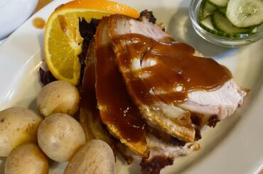 Danish style roast pork with boiled potatoes, red cabbage, and cucumber salad in Copenhagen