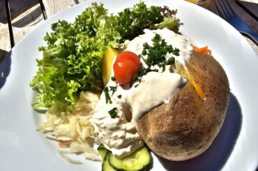 Hot jacket potato with sour cream and mixed salad