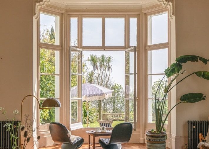 Drawing room with a front garden facing huge bay window in a coastal villa, Kingsdown, Kent, England [711x1067]