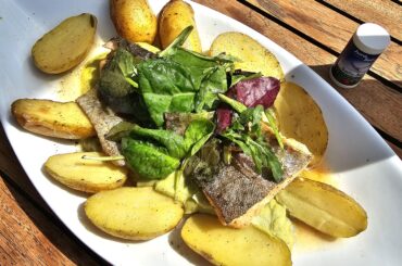 Fried salmon trout fillet on broccoli and lime cream with rosemary butter and swivel potatoes; served in Allensbach, Lake Constance, Germany