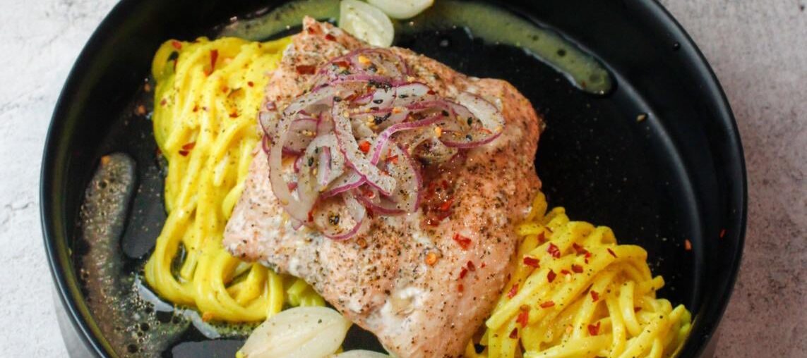 Trout & pearl onions cooked en papillote with beurre blanc & white wine served on a bed of pasta in a mustard & lemon sauce