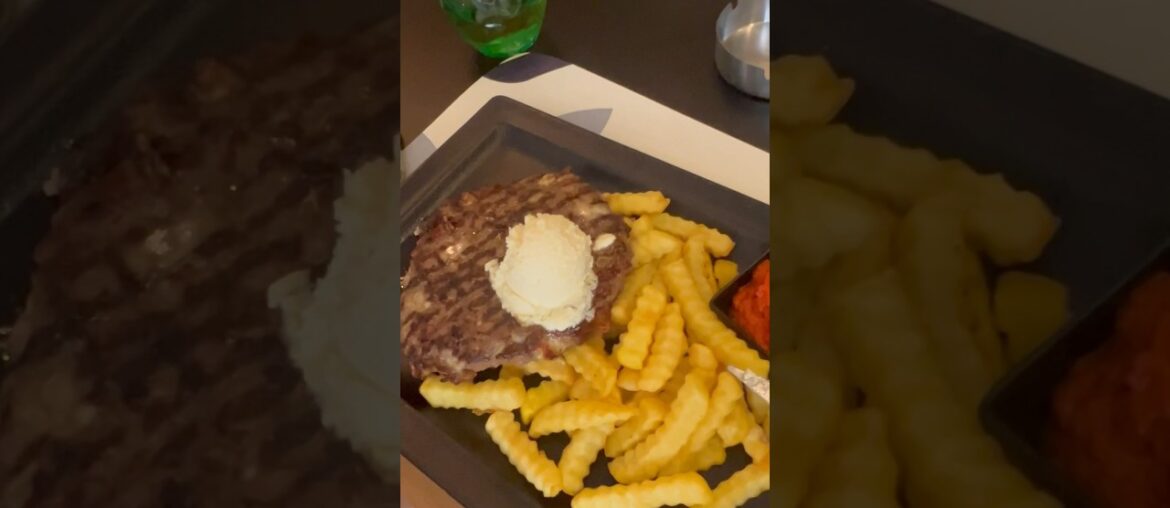 A gourmet flapper filled with cheese and pieces of bacon with french fries.