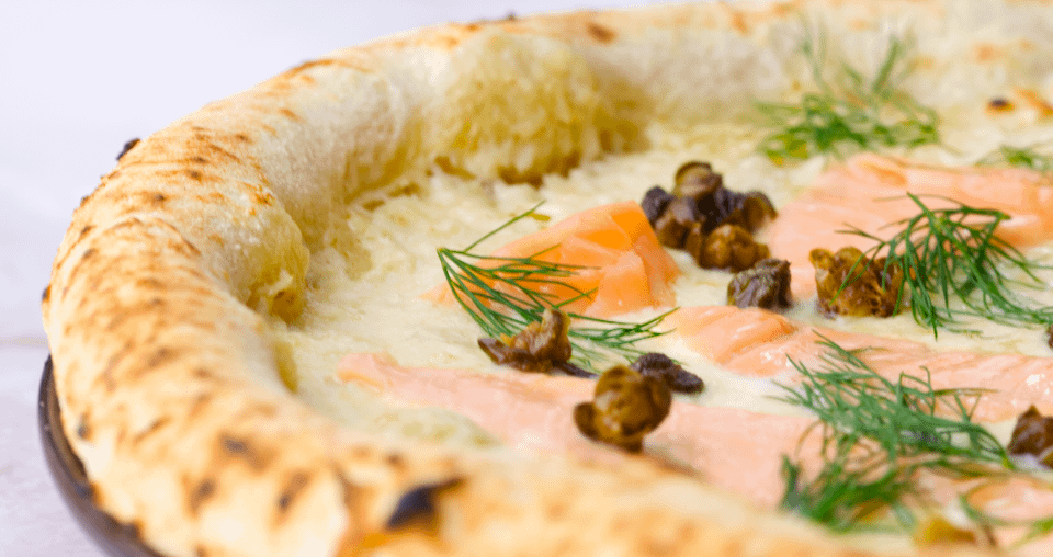 Pizza Napoletana Salmone - Horseraddish/mascarpone base, fior di latte, fried capers, salmon, dill.