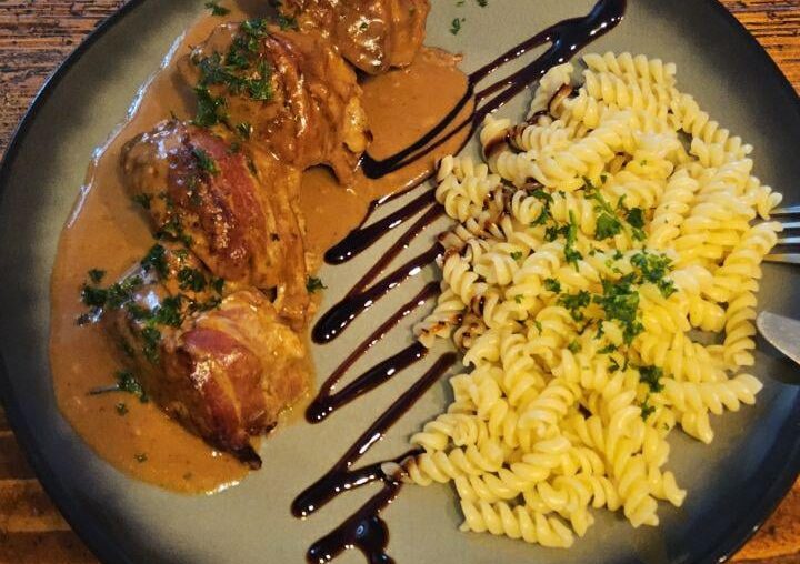 Meatballs with mozzarella filling, wrapped in bacon. Cream sauce. Noodles tossed in a bit of butter and herbs.