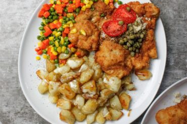 Pork Schnitzel topped with freshly grated horseradish & capers, served with butter sautéed vegetables & roasted potatoes w. Cream sauce