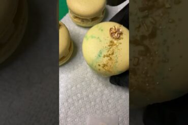 French meringue macaroons filled with gum mastic and vanilla bean ganache with caramel pistachios