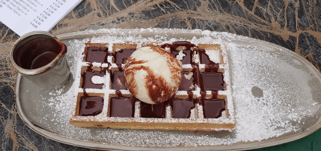 Belgian waffle with warm chocolate sauce in Bruges