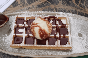 Belgian waffle with warm chocolate sauce in Bruges