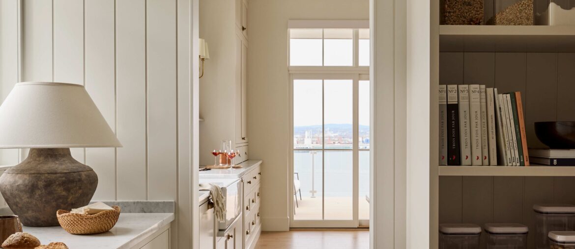 Kitchen and dining space with views of Quebec City across the St. Lawrence River seen through the arched pantry entrance, Lévis, eastern Quebec, Canada [4541x6103]