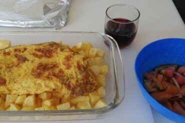 Cooking fried potatoes and a cheese omelette for 2 with a small tomato & onion side salad