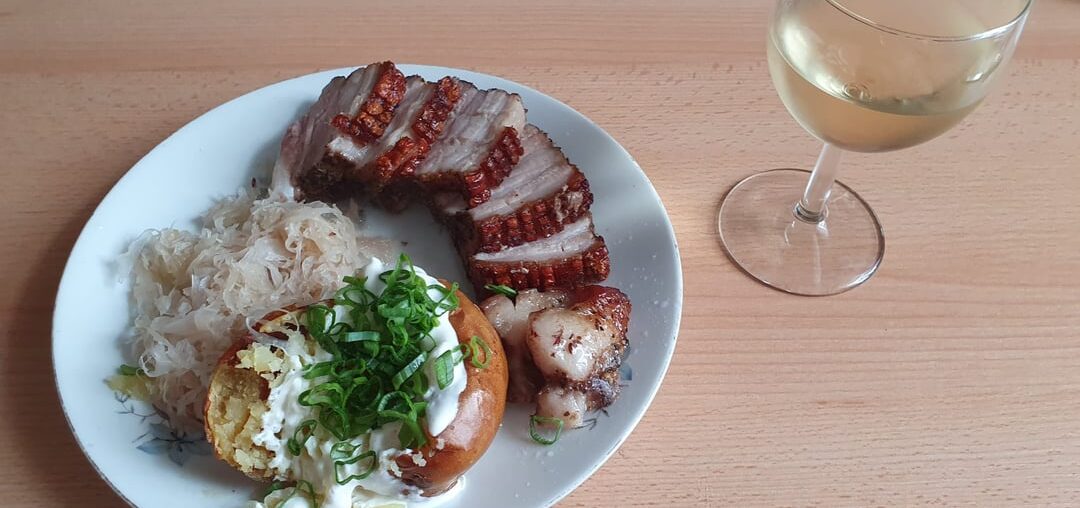 Roasted pork belly with baked potato and sauerkraut