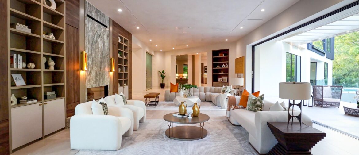 Massive Living Room With Built-Ins, Marble Fireplace, and Huge Floor to Ceiling Sliding Door Leading To Gorgeous Pool and Outdoor Space Located in Houston, Texas [3456×1944]