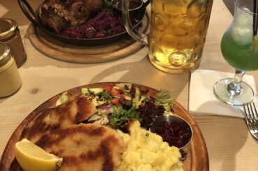 Pork schnitzel, potato salad and greens