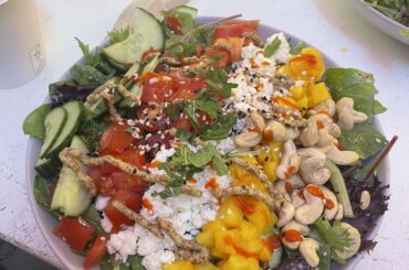 Salad with cucumber, tomato, feta, mango, and cashews