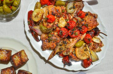 Roasted chicken with cherry tomatoes, green olives, capers and lemon served with ultra crispy potato layers and gorgonzola-based dip