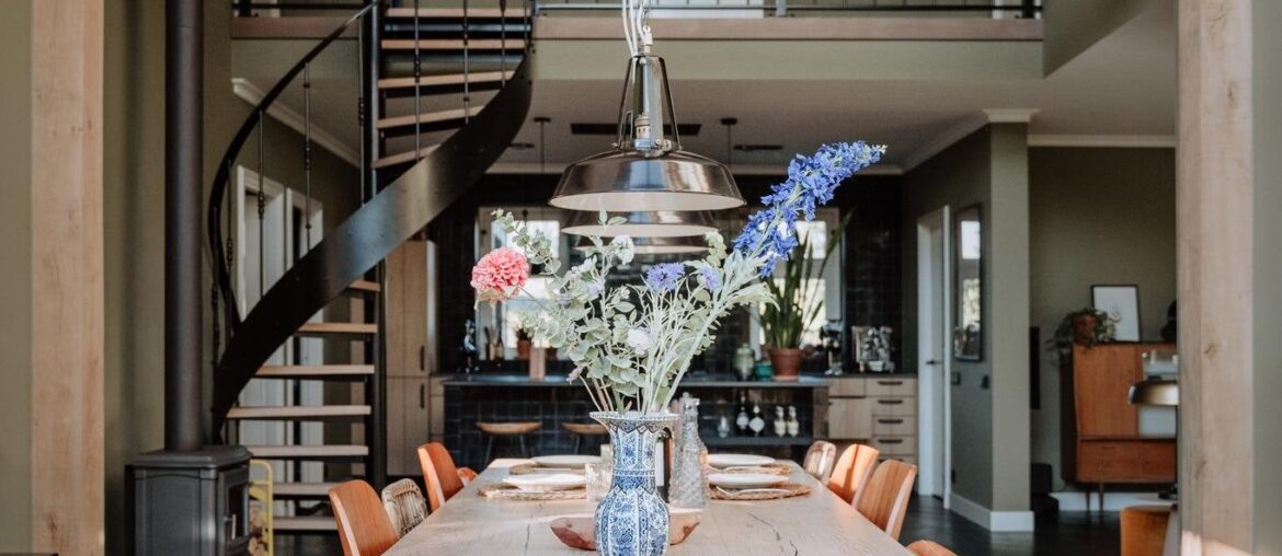 High vaulted ceiling dining space with a black herringbone floor in a house near Den Bosch, the Netherlands [1365x2048]