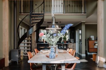 High vaulted ceiling dining space with a black herringbone floor in a house near Den Bosch, the Netherlands [1365x2048]