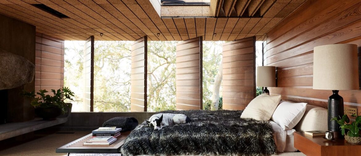 Bedroom with pivoting wood panels in a midcentury home in Silver Lake, Los Angeles [2208x1472]