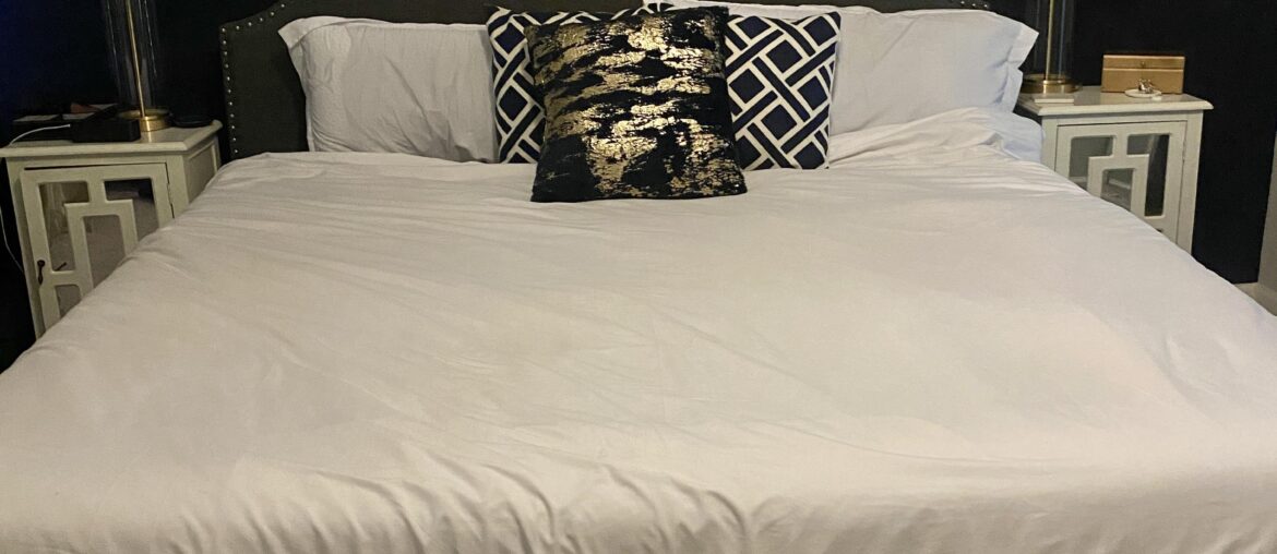 How can I make my bedroom feel more professionally decorated?