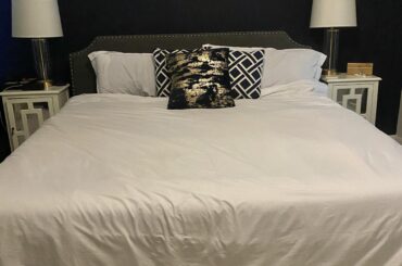 How can I make my bedroom feel more professionally decorated?
