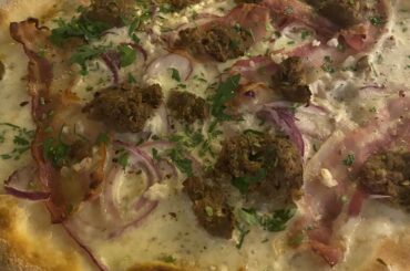 loosely based on flammkuchen - flatbread with white truffle cream base, mozzarella, pancetta, garlic, onion, sausage & herbs