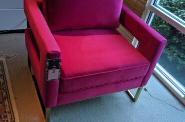 What color furniture to mute down a neon pink accent chair?