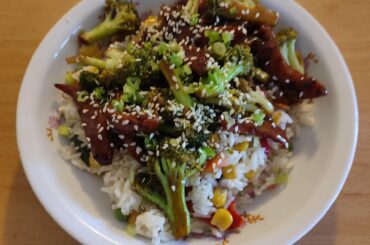 Stir fried broccoli and sausage over rice and veggies