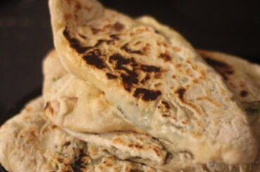 Zhingyalov hats (flatbread stuffed with finely diced herbs and green vegetables. It is a traditional dish of Armenians from Artsakh and Syunik and has traditionally been a staple in times of scarcity, such as famine and war).