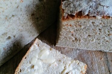 freshly baked sourdough bread, the first slice with butter&salt