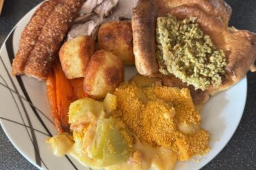Roast pork dinner with Yorkshire pudding, cauliflower cheese, honey roasted carrots, stuffing and roast potatoes
