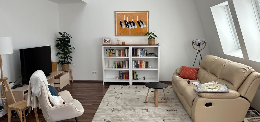 Make grey armchair work in warm beige living room?