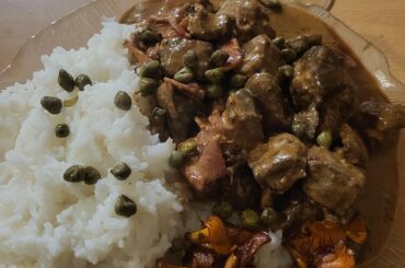 Moose calf liver stewed in cream with bacon and some cognac, served with rice, butterfried chanterelle mushrooms, and some capers.