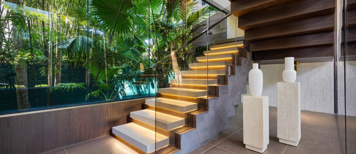 Foyer Featuring Glass Wall with Lush Tropical Landscape and a Modern Staircase in a Miami Beach, FL Home [5000×3337]