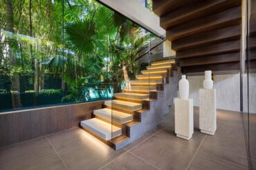 Foyer Featuring Glass Wall with Lush Tropical Landscape and a Modern Staircase in a Miami Beach, FL Home [5000×3337]