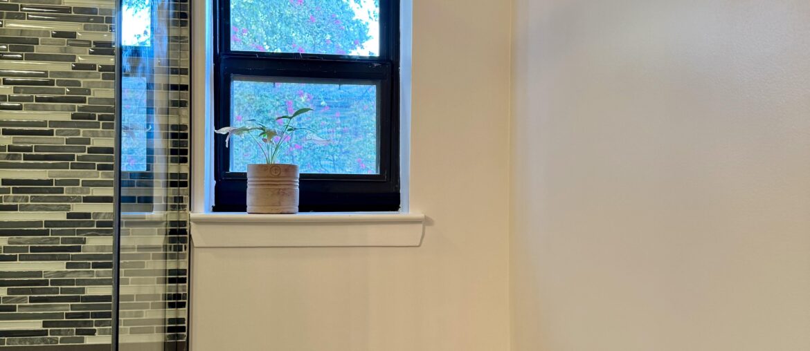 What do you envision for this bathroom wall with an off-center window?