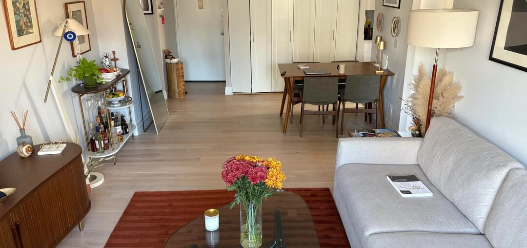 How would you recommend adding cushions and throw blankets to this living room? I'm looking for suggestions on colors, types, and positioning. I’ve attached two pictures to give a better idea of the couch color and the rest of the living room decor