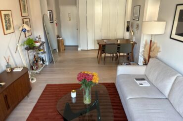 How would you recommend adding cushions and throw blankets to this living room? I'm looking for suggestions on colors, types, and positioning. I’ve attached two pictures to give a better idea of the couch color and the rest of the living room decor