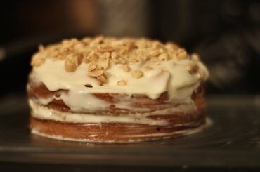 Simple homemade cake: lemon sponge, condensed milk cream and salted peanuts.