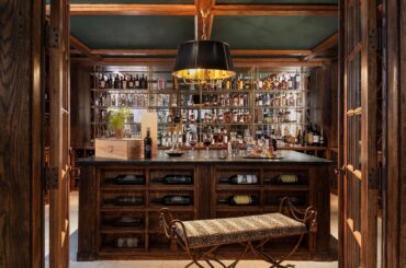 Well-stocked home bar in a maximalist house, Chicago suburb of Hinsdale, Illinois [3000x1791]
