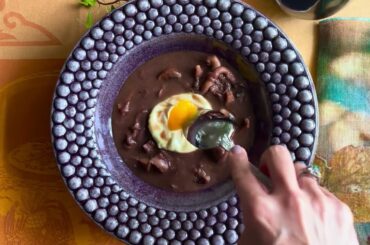 Oeuf Meurette. Poached egg, wild mushrooms, lardon, red wine sauce.