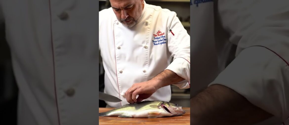 French chef cooks largemouth bass fish in his restaurant