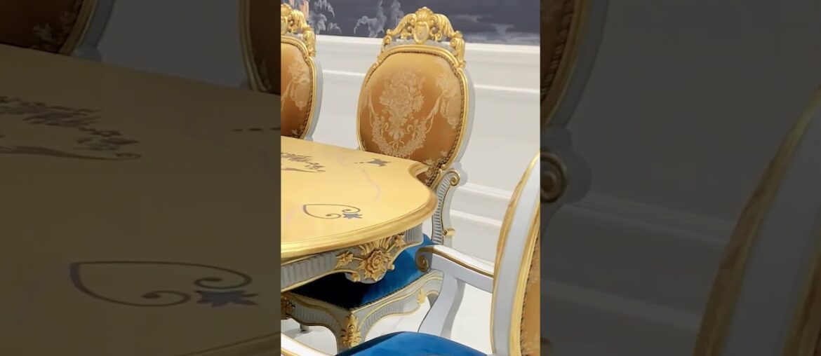 A French carved dining table, a circle of jacquard high-back chairs