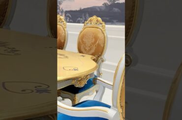 A French carved dining table, a circle of jacquard high-back chairs