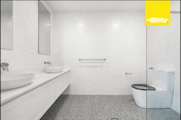 How can I minimise the look of the overly large disabled toilet?