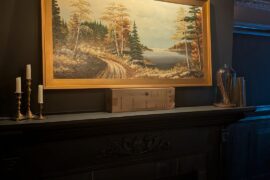 How high should I hang this painting? Right now it's sitting on a box, 5.5 inches above mantle.