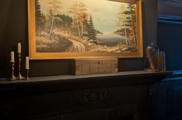 How high should I hang this painting? Right now it's sitting on a box, 5.5 inches above mantle.