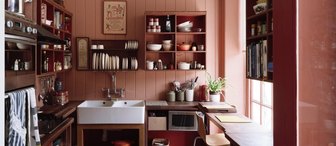 Kitchen with V-groove panelling painted in a warm salmon shade in an 18th-century country house in a rural estate, Kent, England [1600x1067]